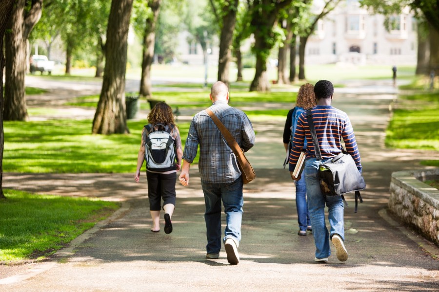 University Students Walking On Campus Road